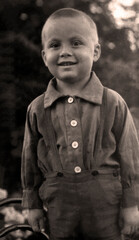 Vintage photo of a smiling boy. Retro portrait from 1942. Photos from the Second World War
