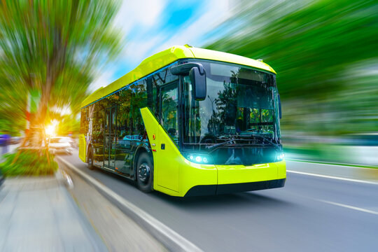 Electric bus with headlights on drive down the street in motion blur speed effect among trees - Powered by Adobe