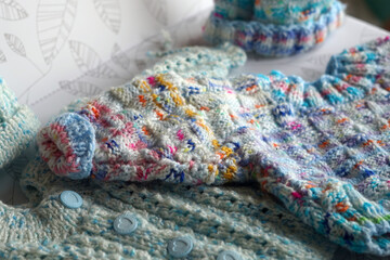 Close-up photos of children's knitted sweaters.