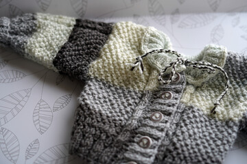 Children's knitted sweater. It has a color in shades of brown.