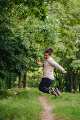 A charismatic man jumping for joy, expressing happiness and excitement. Perfect for topics on celebration, joy, and positive emotions