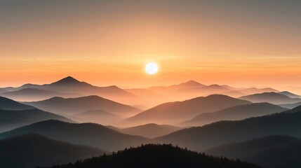 Serene sunrise over layered mountain ranges with soft mist and warm hues in the sky