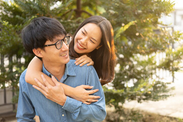Fototapeta premium close up asian couple lover embrace and smile with happiness feeling at outside home garden in the morning for healthy relationship and family lifestyle concept