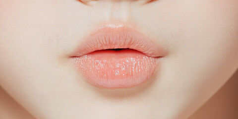 Obraz premium Close-up Image of Peach-Colored Lips and Adjacent Facial Skin