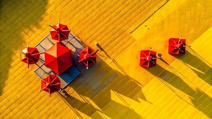 Obraz premium Abstract Red Shapes on Yellow Background: Aerial Drone View of a Break Time