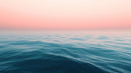 Obraz premium A serene gradient seascape with a deep blue ocean transitioning to a soft pink sky at the horizon