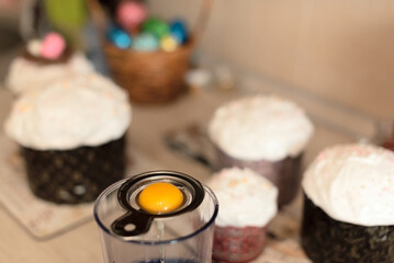 Egg yolk close up with selective focus during making homemade Easter cake at home. Happy Easter concept. Process of cooking at home