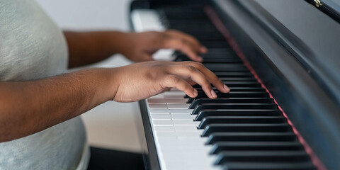 Fototapeta premium Close-up of Hands Playing Piano Keyboard