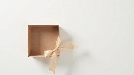 Fototapeta premium An Empty Gift Box with a Delicate Beige Ribbon, Ready for a Special Surprise