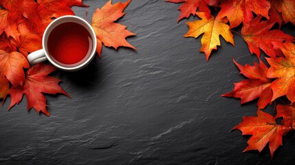 Warm Tea Cup Surrounded by Autumn Leaves on Dark Stone Surface