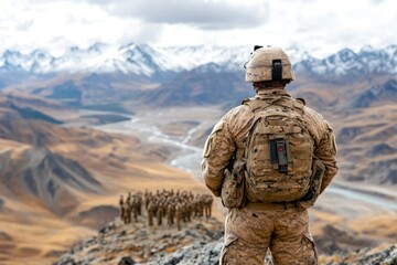 A military officer standing on a hill, overseeing troops in formation during a training exercise