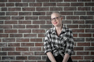 Portrait of a beautiful young caucasian woman with shaved head. Female cancer survivor. Smiling...