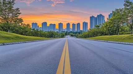 Obraz premium Asphalt Road Leading to Modern City Skyline at Sunset
