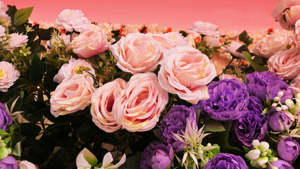 The stage of a ceremonial function is decorated with artificial flowers