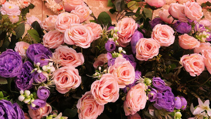 The stage of a ceremonial function is decorated with artificial flowers