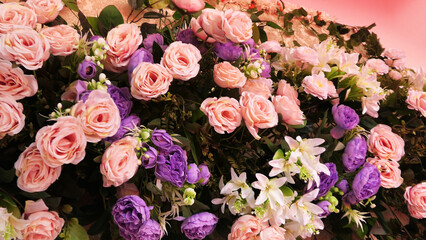 The stage of a ceremonial function is decorated with artificial flowers