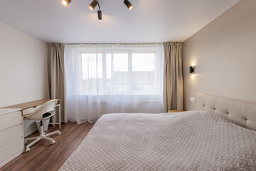 Minimalism Young Adult Living Room Interior. Bed and Coffee Table. Gray Blanket on the Bed. Windows and Curtains. LED Light. Windows and Curtains