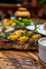 Enjoy a grilled steak with shrimp and vibrant garnishes for an unforgettable meal