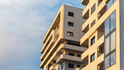 Modern apartment building with curved balconies in sunlight, Bar, Montenegro