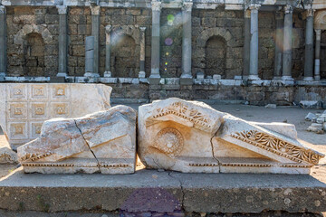 Ancient carved marble fragments of a temple facade with decorative motifs in Side, Turkey (Turkiye)
