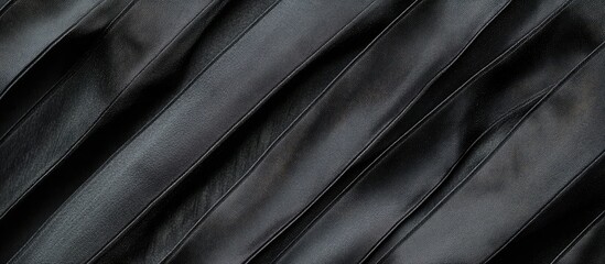 Obraz premium Elegant Black Striped Satin Fabric Texture with Diagonal Lines and Copyspace for Text Perfect for Design and Advertising Applications