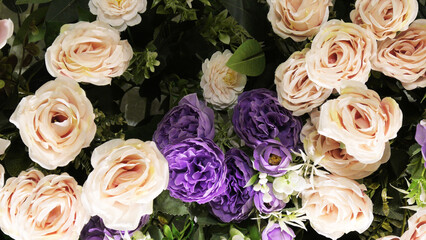 The stage of a ceremonial function is decorated with artificial flowers