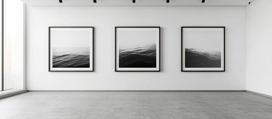Modern Minimalist Gallery Featuring Black and White Wooden Frames Displaying Abstract Sea Art with Ample Copyspace for Text
