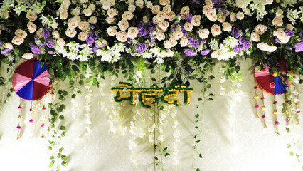The stage of a marriage function in India is decorated with artificial flowers
