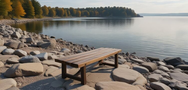 Solo wooden bench sits atop a rocky shoreline overlooking Pewaukee Lake on a gray morning, wisconsin, peaceful