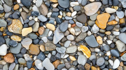 Colorful collection of smooth pebbles on a beach creating a natural textured background ideal for serene and tranquil themes