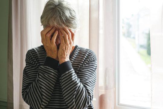 worried senior woman at home felling very bad