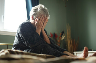 tired senior woman on her bed