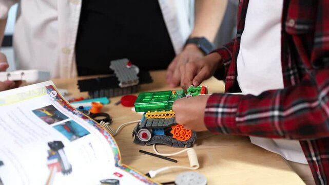 Children working on a robot design in Robotics programming class. STEM education using constructor blocks and laptop, Technology educational development for school kids