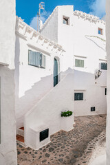 Narrow whitewashed alleys of Binibeca Vell, Menorca. A charming Mediterranean village with traditional Balearic architecture and serene coastal vibes.