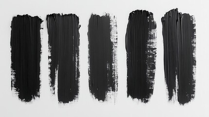 Fototapeta premium Five vertical black paint strokes on a white background, varying in texture and opacity. Each stroke shows brushstrokes and texture