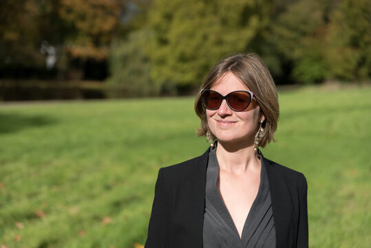 Outdoor portrait of a 31 yo woman in the Stuyvenberg Royal city park, Laeken , Brussels, Belgium