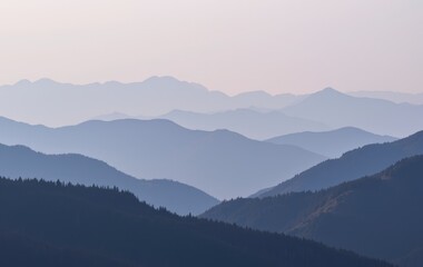 Obraz premium Serene Layers of Blue Mountains Misty Peaks and Rolling Hills Landscape