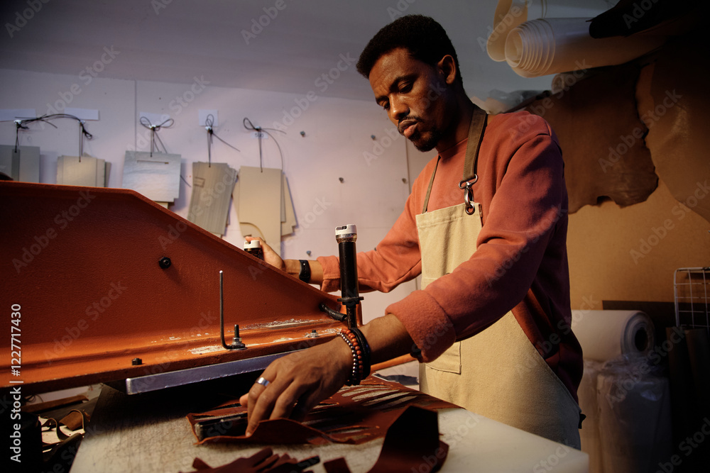 Poster man in workshop crafting leather goods meticulously with tools surrounding. focused and skillfully w