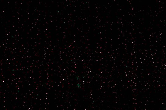 small star flashlights on a black background