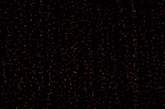 small star flashlights on a black background