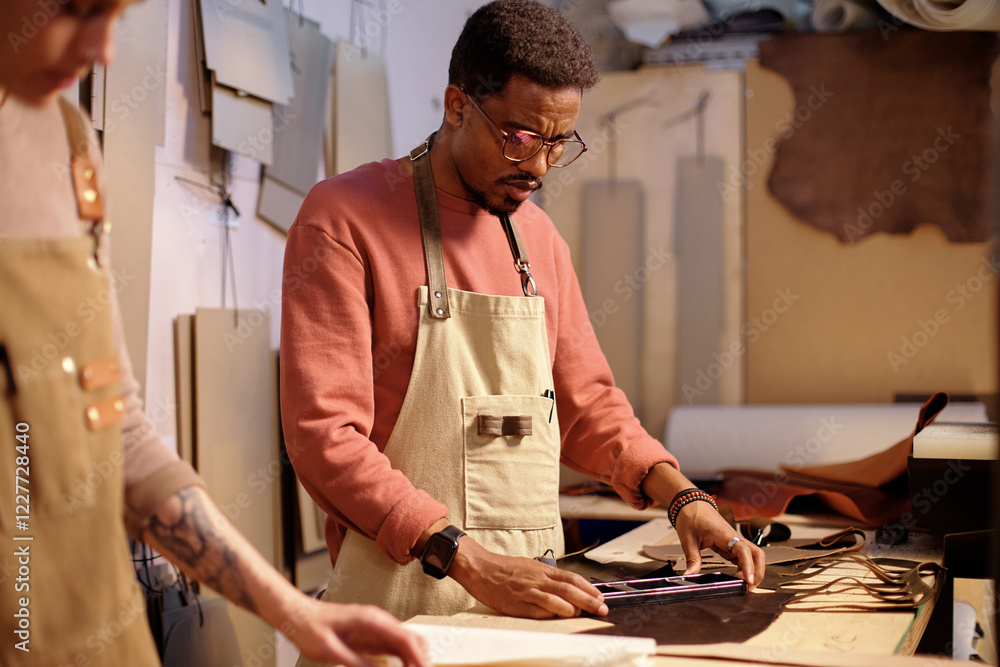 Poster man using tools in workshop, focusing on precise measurements. worker wearing apron and eyeglasses, 