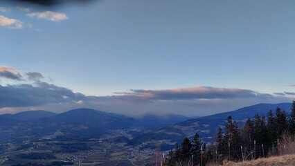 Fototapeta premium Panorama of a valley with a rolling horizon in the clouds. Europe