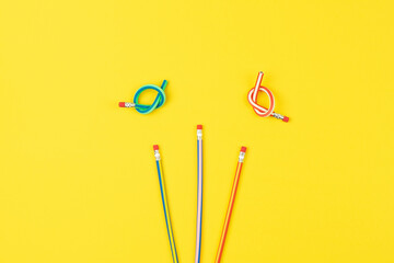 Flex pencils on yellow background, increase creative potential for playful kids crafts. Simple shape unleashes creative fun, inspiring creative exploration and develops fine motor skills of hands