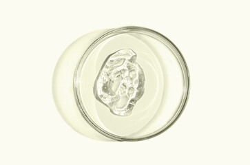 Skin serum or face wash gel in a Petri dish. For cosmetic procedures.