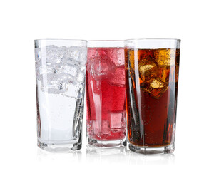 Soda water of different flavors with ice cubes in glasses isolated on white