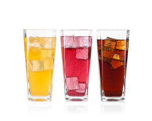 Soda water of different flavors with ice cubes in glasses isolated on white