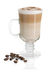 Tasty latte macchiato in glass cup and coffee beans isolated on white