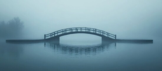 Fototapeta premium Misty bridge over tranquil water with serene reflection and ample space for text or messaging.