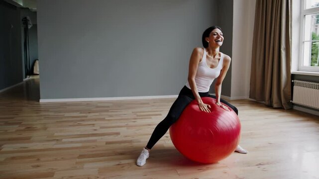 Woman Playfully Bouncing on Yoga Ball