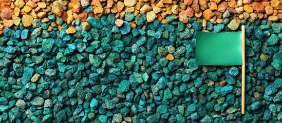 Green Flag on Colorful Gravel Background with Environmental Awareness Theme and Empty Space for Your Custom Text or Message